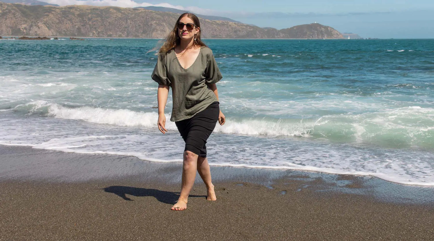 sage coloured linen designer top with puffy sleeves on breaker bay beach
