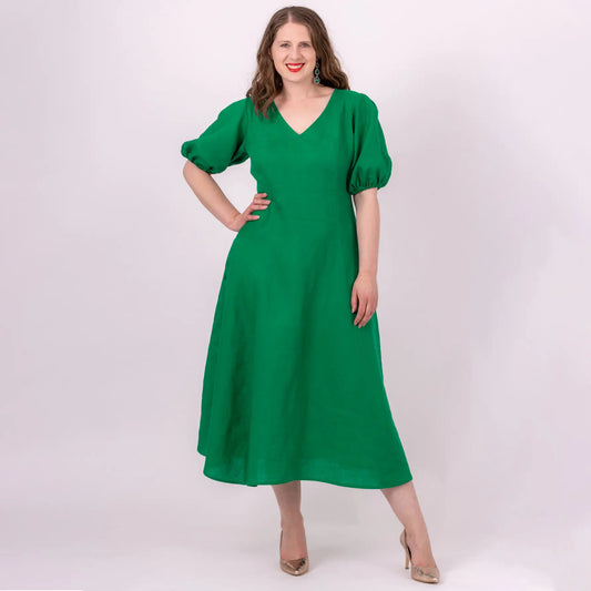 green linen midi length dress with puffy sleeves and pockets